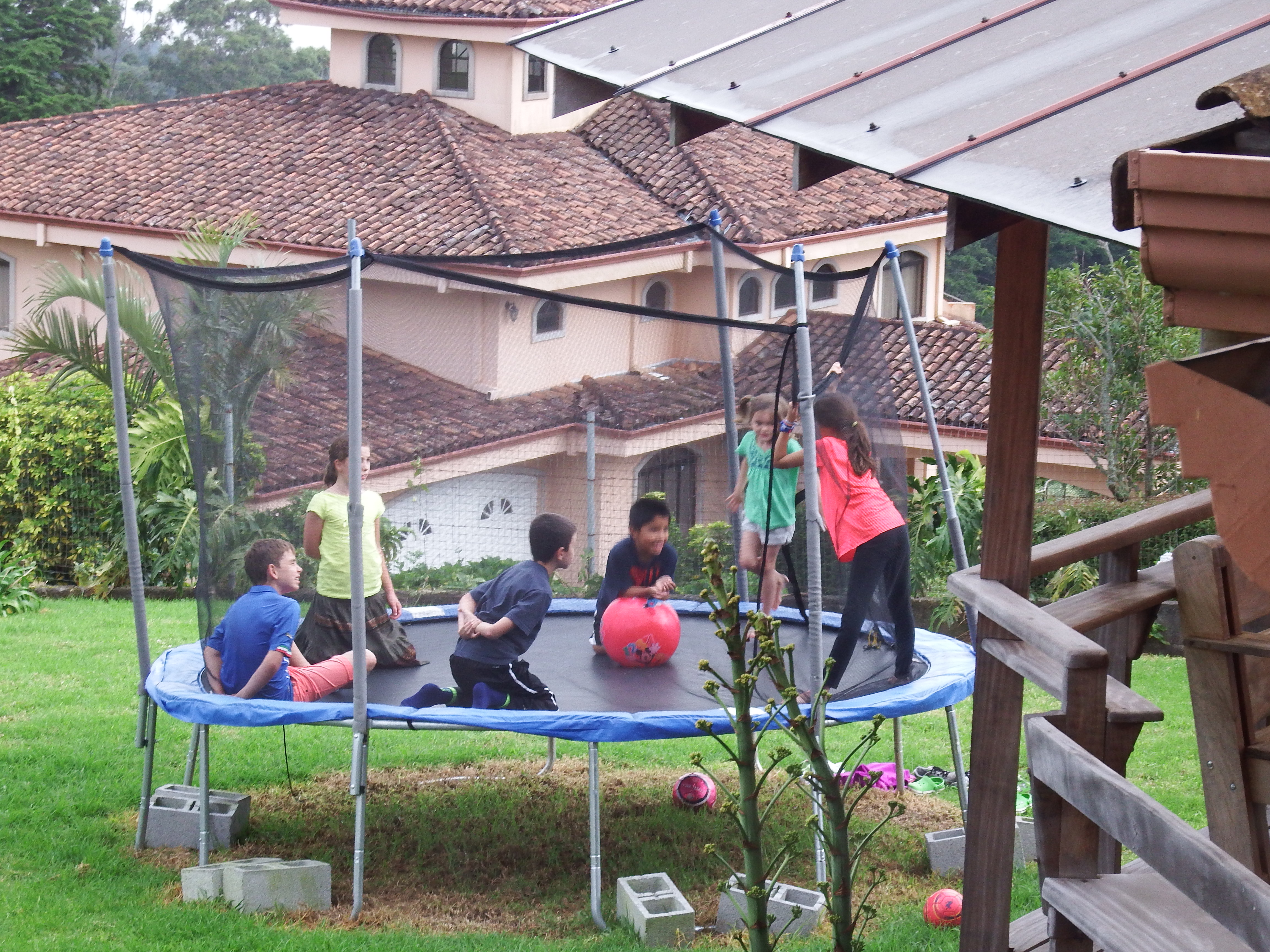 Playing with neighborhood kids on the trampoline.