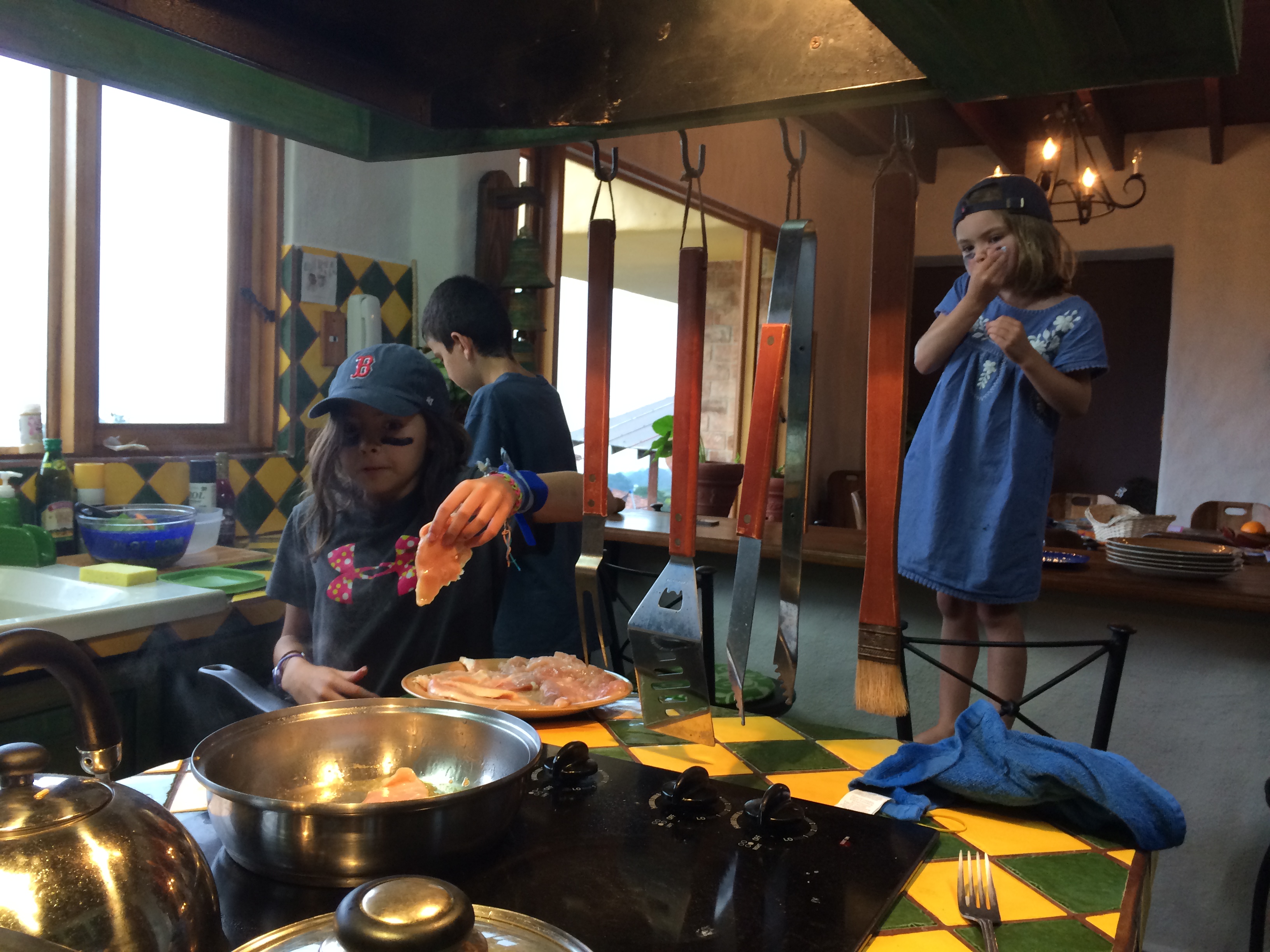 Making dinner (can't remember the kids helping us cook this much at home!)