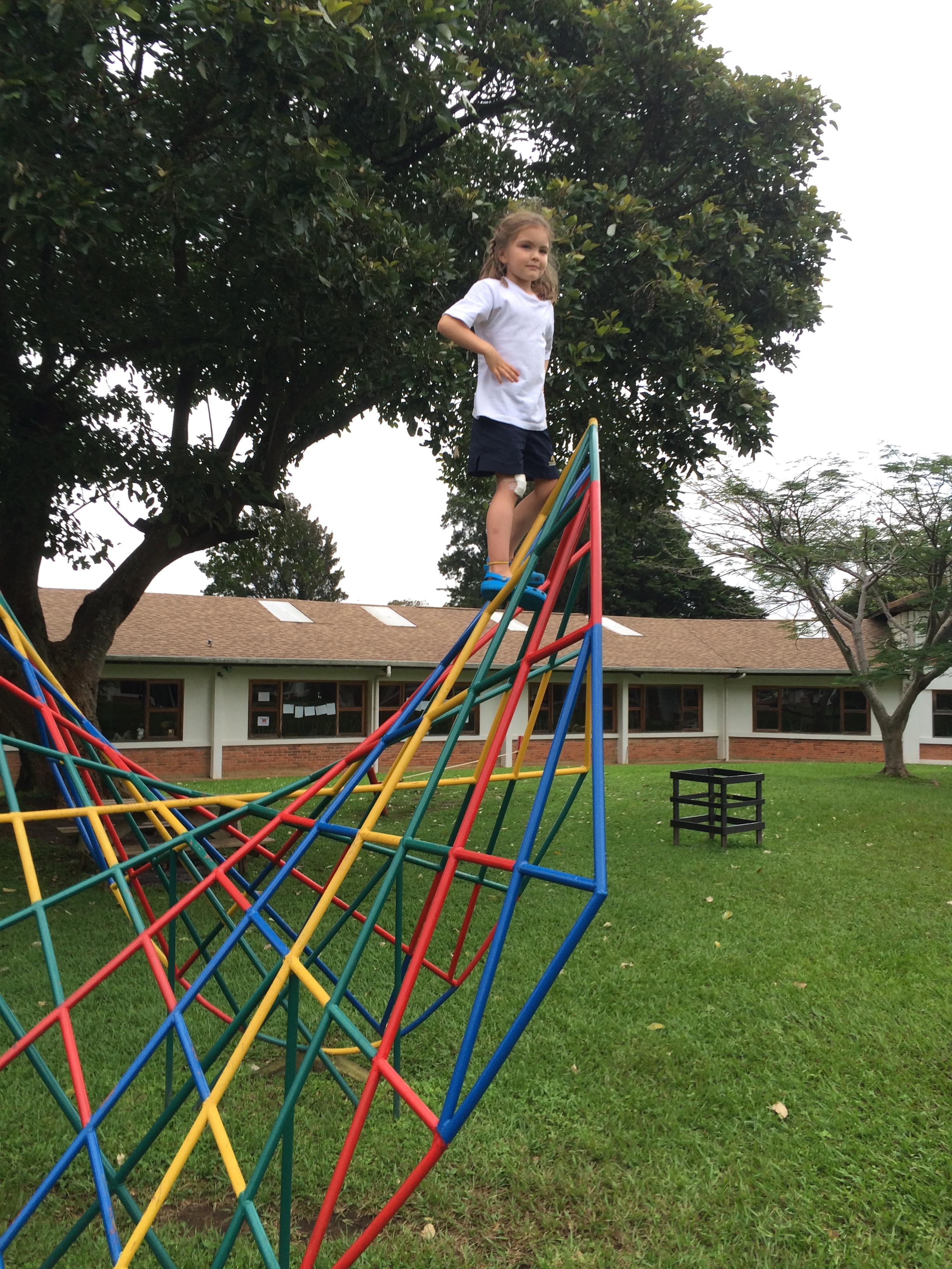 A few days later...she wouldn't let the ankle or knee gashes keep her down (this is on one of the school playgrounds).  