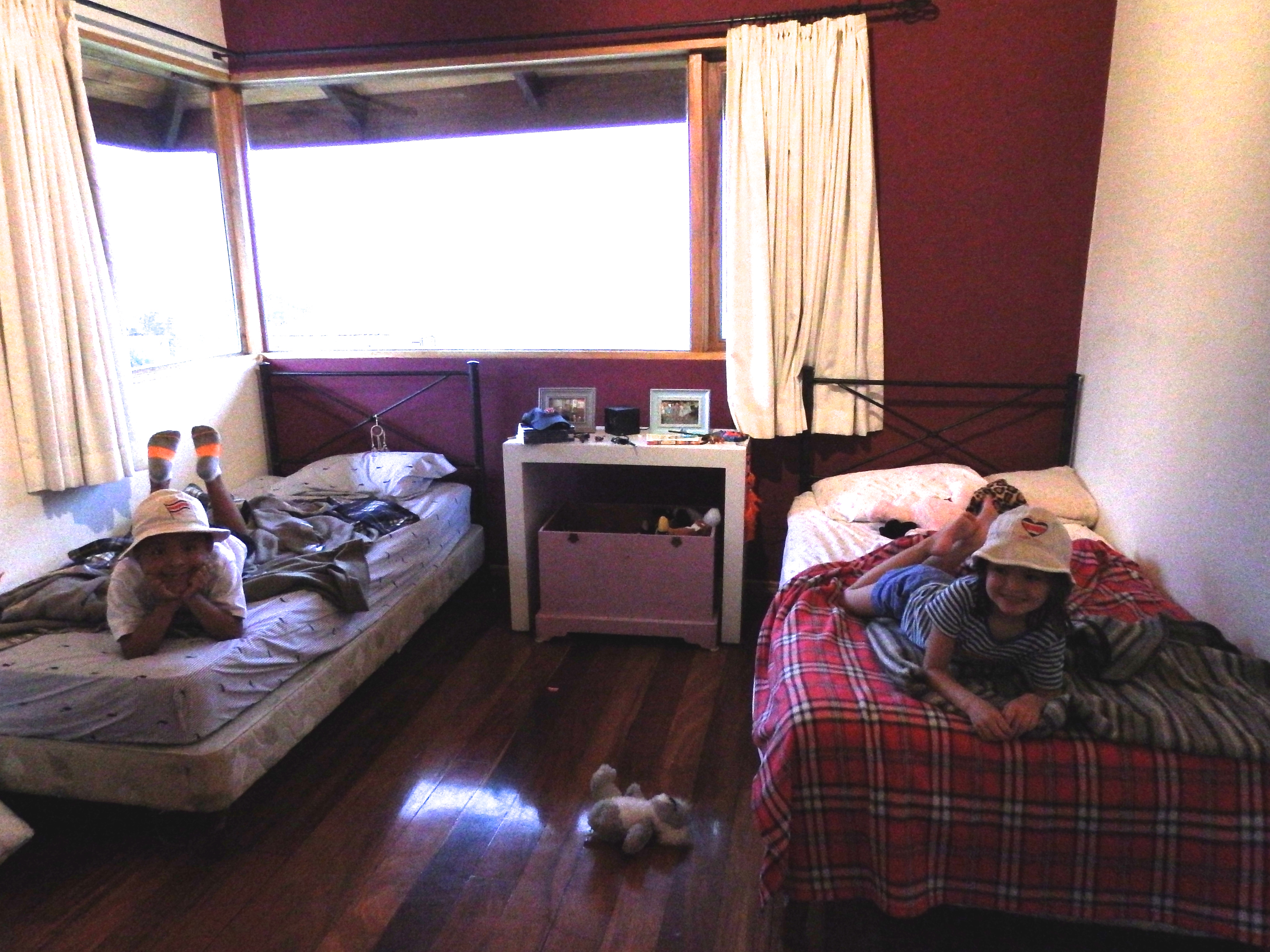 Charlie and Lulu's room.  They both wanted to wear their Costa Rica hats for the picture.  Note the framed pictures near their beds - friends from home. :)
