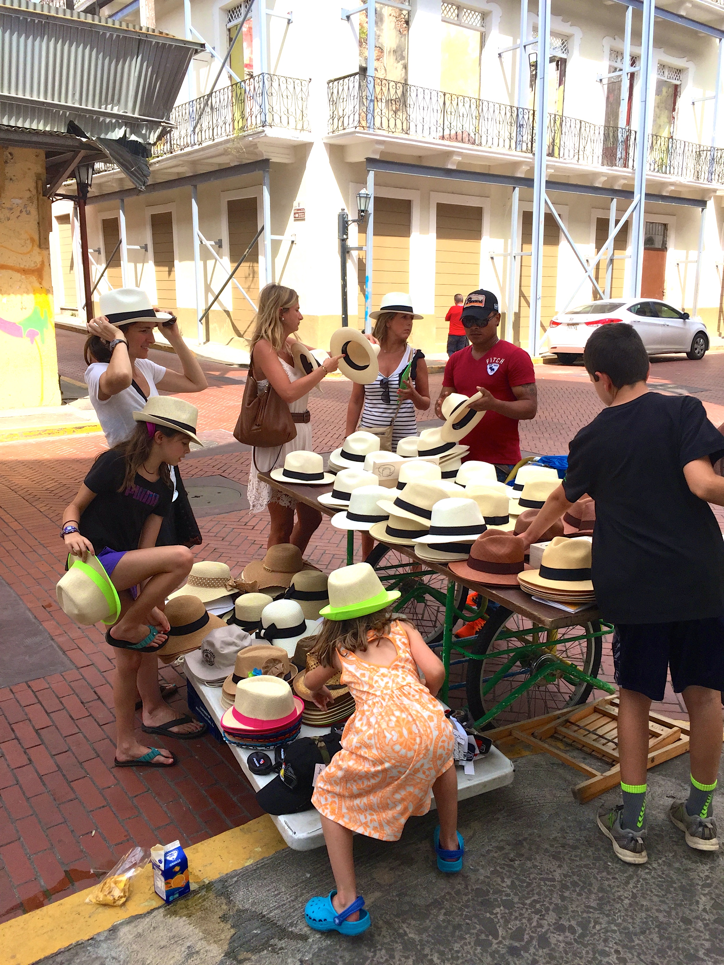 Stopping at a hat stand on the street.