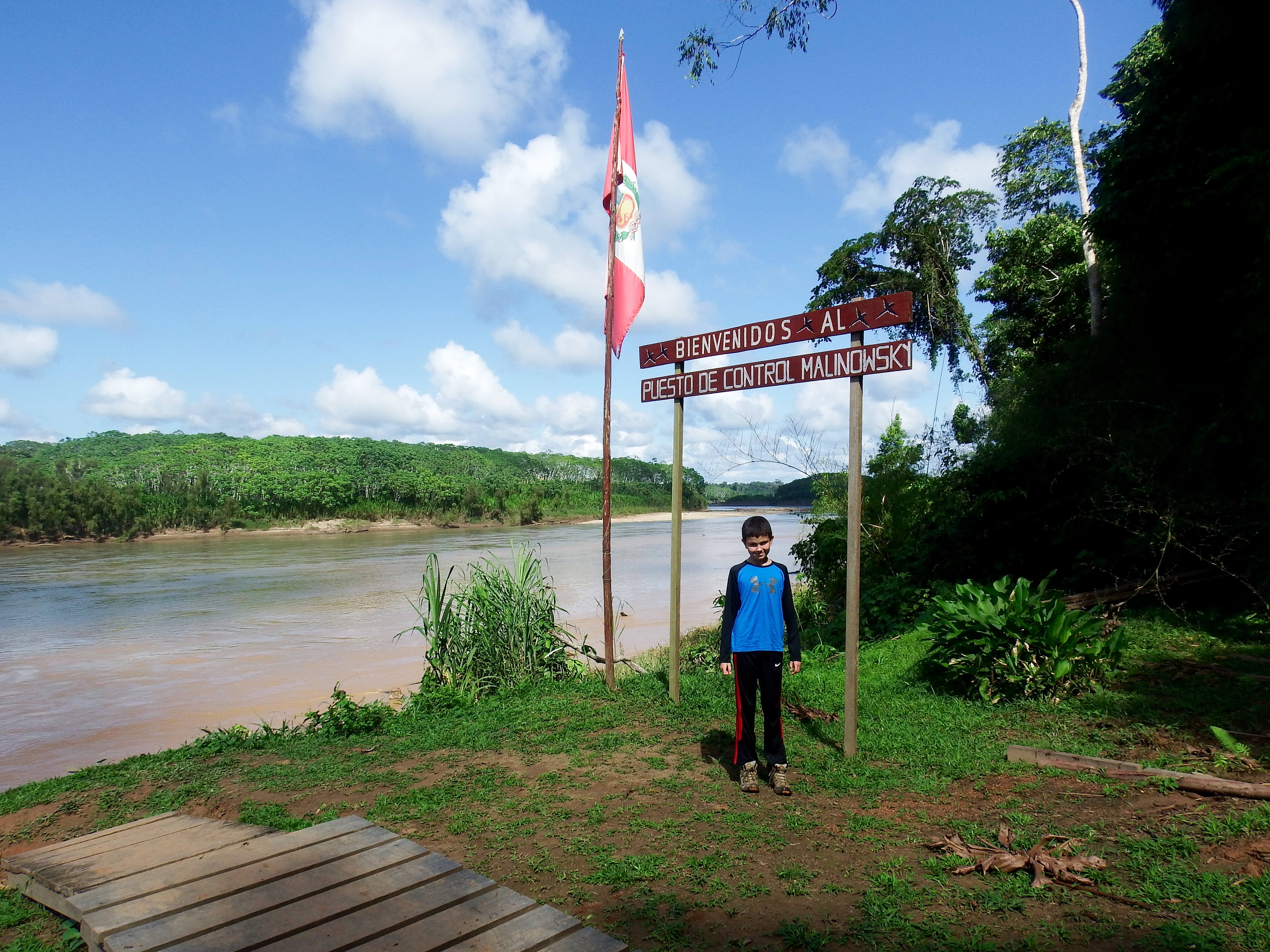 Jack at the sign outside the "last human outpost" before entering the reserve (TRC is another few hours up river!)