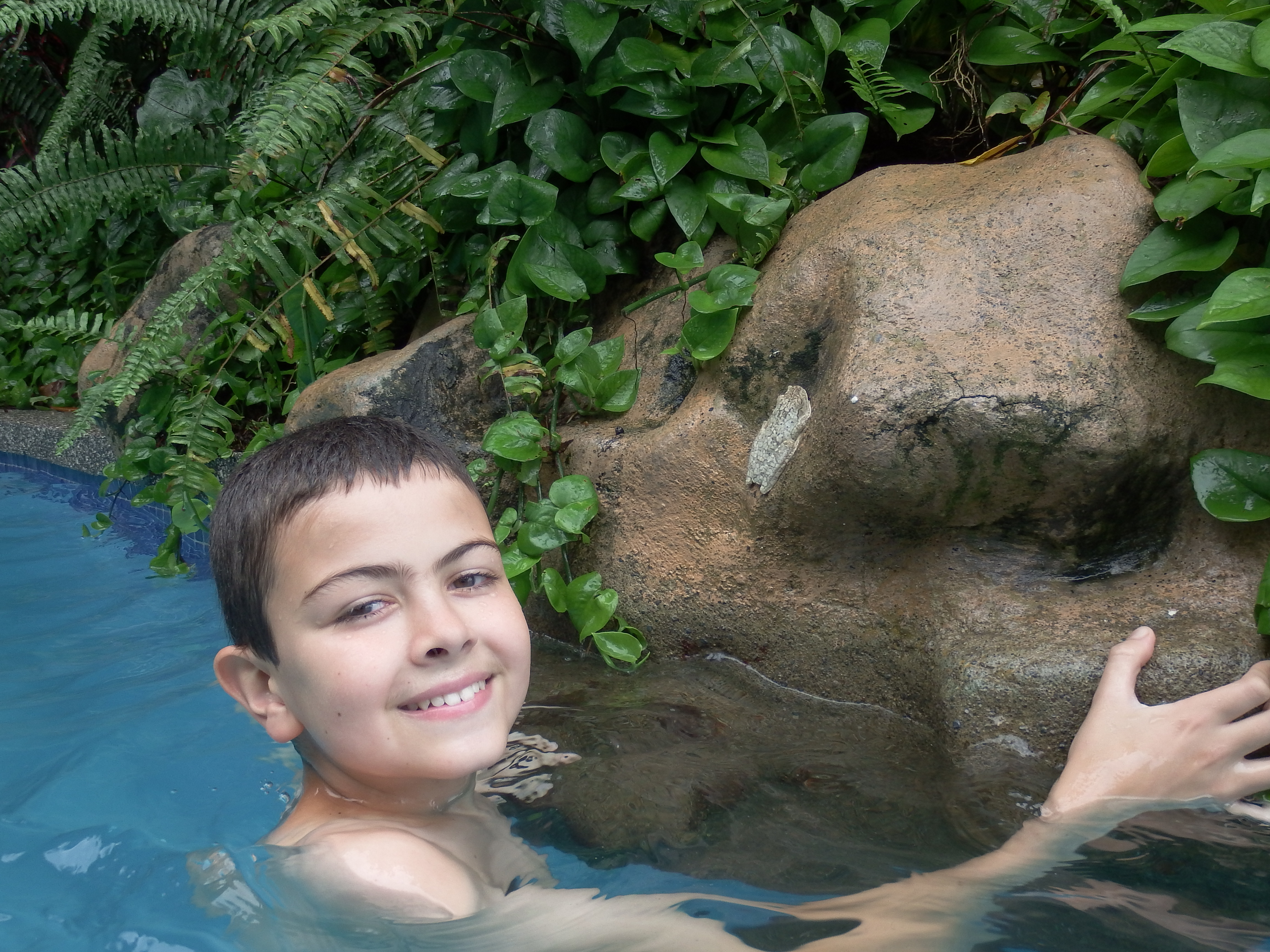 Jack with the frog he spotted hanging onto a rock by the pool