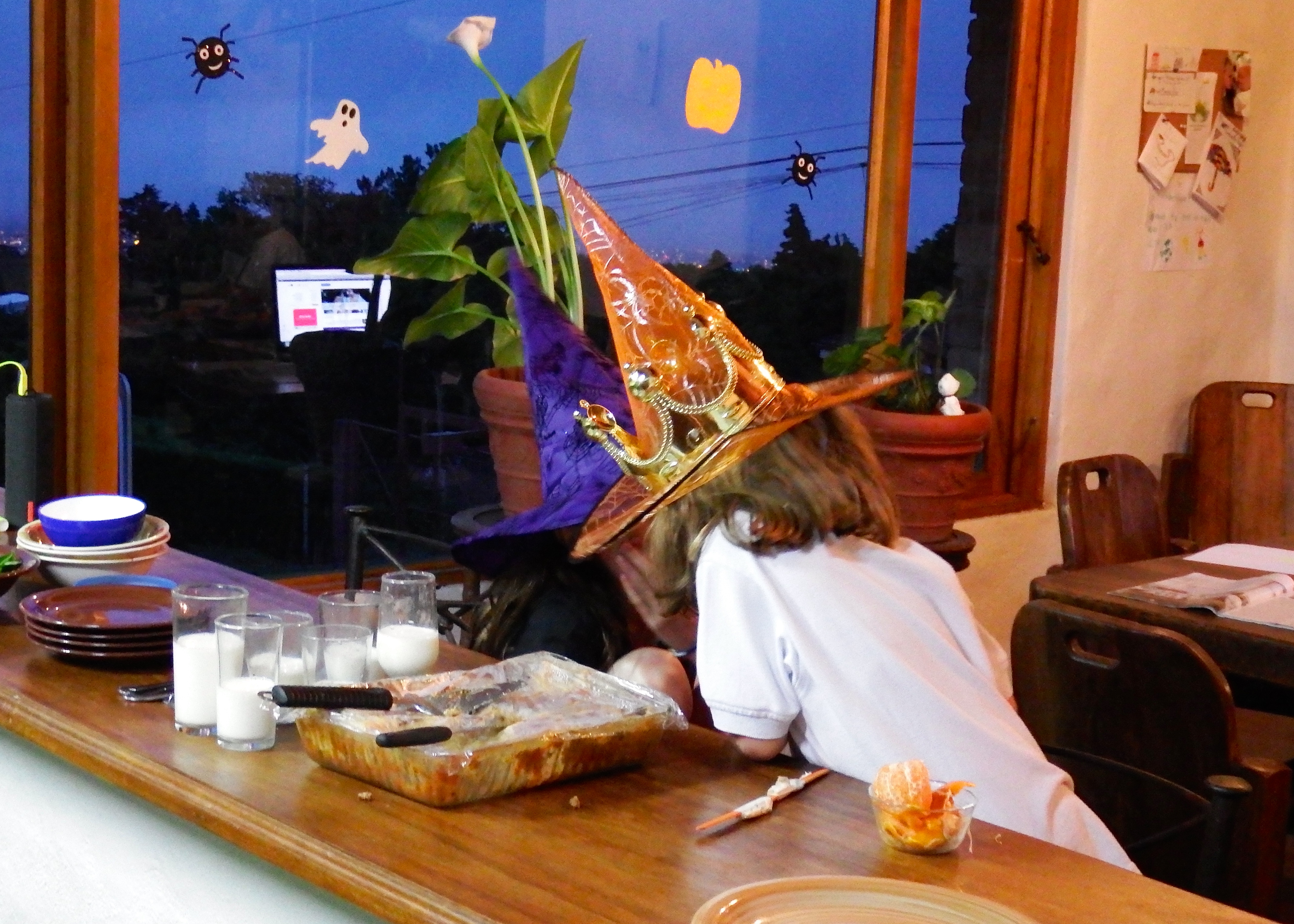 Lia and Ella put their witch-heads together for some planning before the candy hunt.