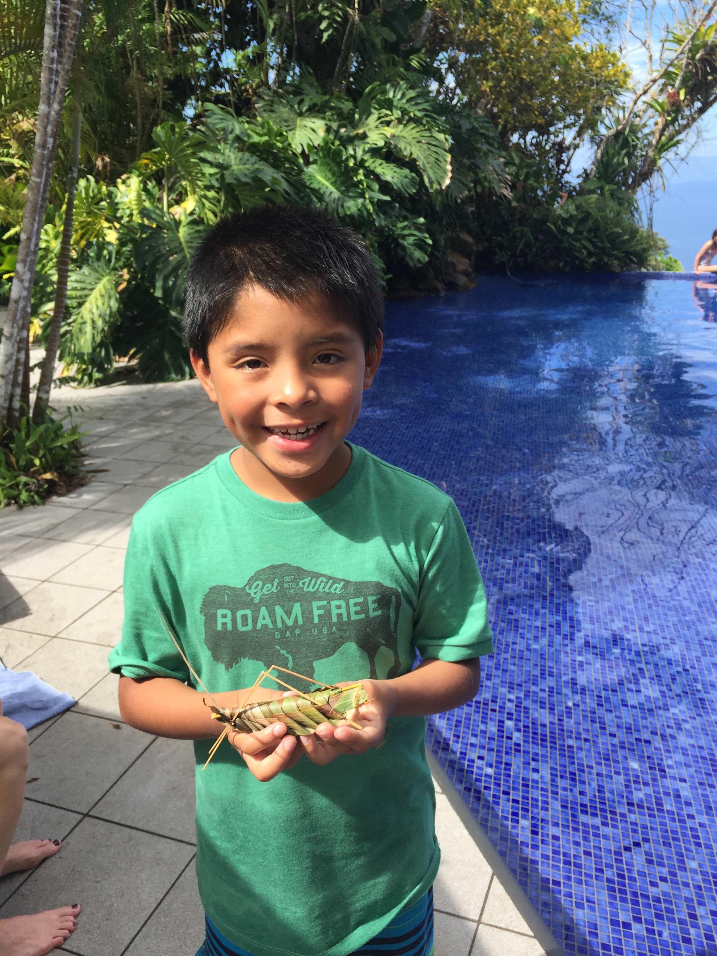 Charlie with his grasshopper (which he made out of palm leaves)