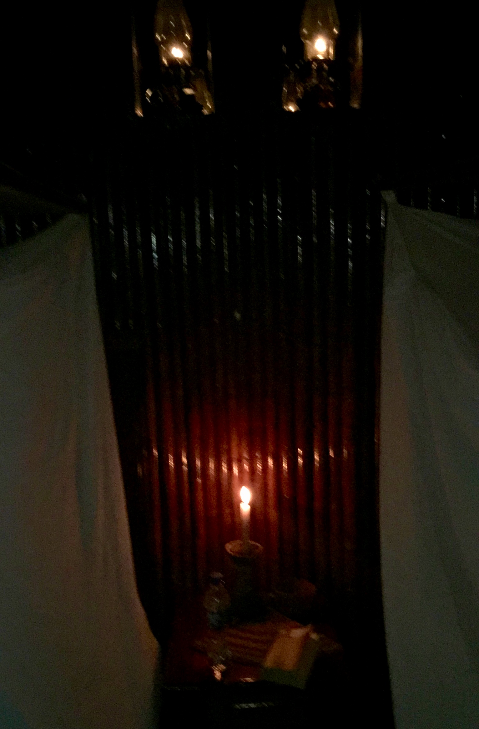 Picture in the dark of one of our rooms. Candle light between the beds.